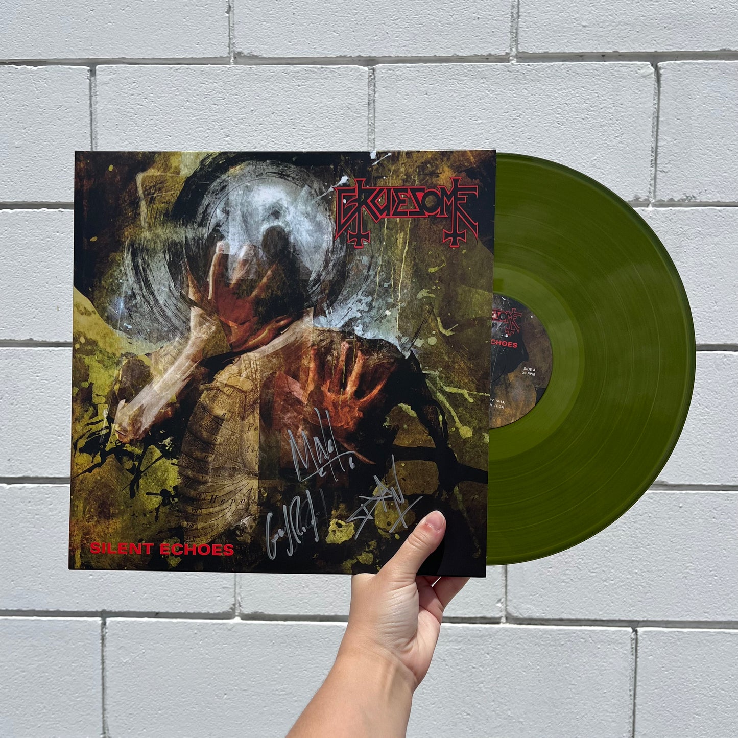 Signed copy of Gruesome - Silent Echoes on Swamp Green vinyl with the disc displayed