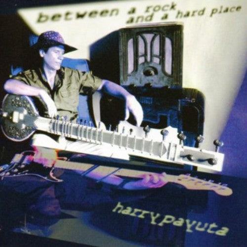 the album cover for Harry Payuta - Between A Rock and A Hard Place