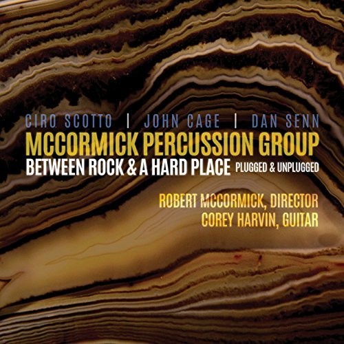 the album cover for Scotto / Cage / Senn - Between Rock & a Hard Place