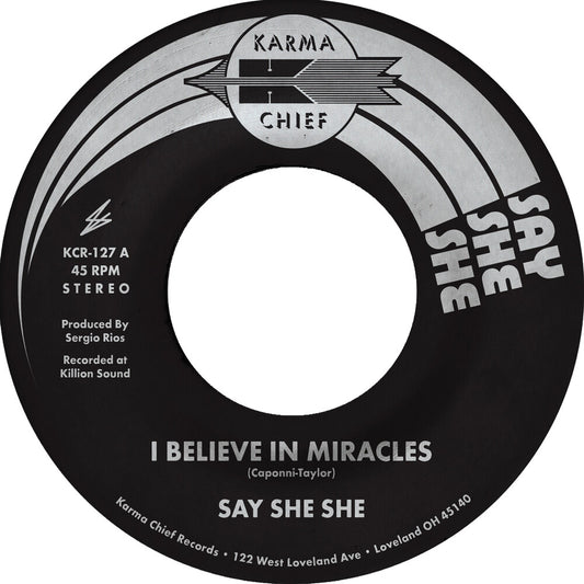 the album cover for Say She She - I Believe In Miracles / C'est Si Bon